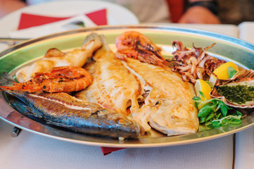 traditional slovenian food, fish plate with seafood, selective focus