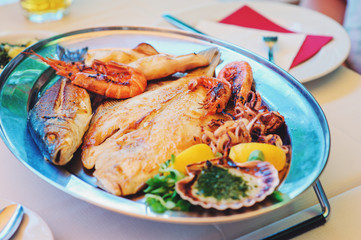 traditional slovenian food, fish plate with seafood, selective focus