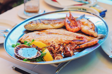 traditional slovenian food, fish plate with seafood, selective focus