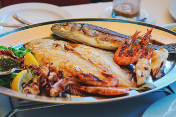 traditional slovenian food, fish plate with seafood, selective focus