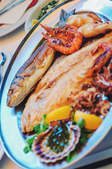 traditional slovenian and croatian cuisine, fish plate with garlic sauce, selective focus
