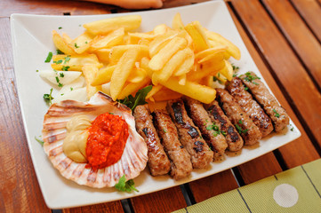 traditional slovenian cuisine, meat kebab - chevapchichi - with french fries