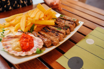 traditional slovenian cuisine, meat kebab - chevapchichi - with french fries