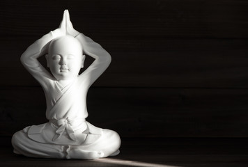 Sitting buddha. White monk. Meditation and relaxing concept