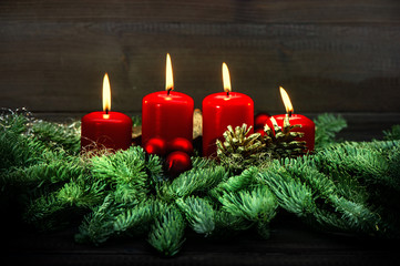 Advent decoration. Four red burning candles. Vintage style