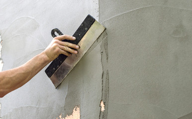 Plastered walls with a spatula