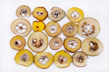 Obraz premium Japanese quince slices of different maturity on white background. ..