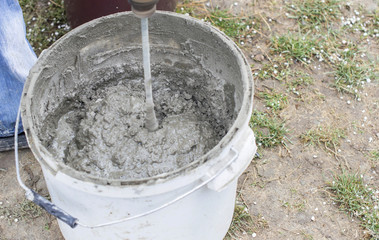 Fototapeta premium Mixing cement solution using electric drills