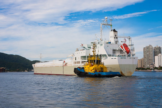 Tugboat guiding a ship