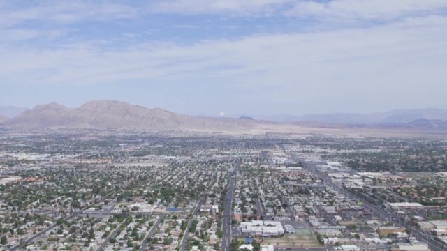 Aerial view from above looking at buildings, mountains and streets of Las Vegas, Nevada, USA