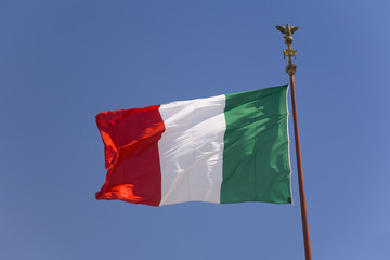 Naklejka na ściany i meble Italian flag flying in blue sky, Rome, Italy, Europe