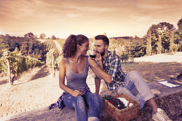 young couple toasting in a vineyard