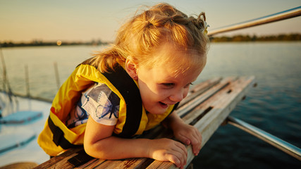 Little girl enjoying ride on yacht