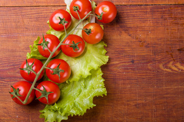 Fresh, ripe cherry tomatoes on an old wood