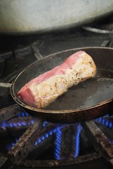 steaks cooking on stove