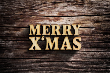 Fototapeta premium Merry X'mas. Words on old wooden board.