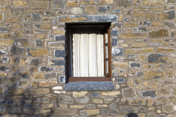 Stone windows of Casa de San Martin Inn, in Aragon, in the Pyrenees Mountains, Province of Huesca, Spain