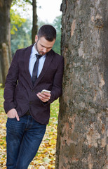 Smiling business man standing outside office building