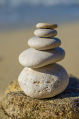 Fototapeta na wymiar Stones balance, pebbles stack over blue sea in Croatia.