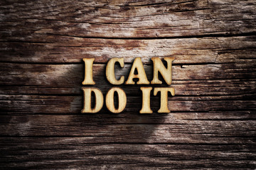 I can do it. Words on old wooden board.
