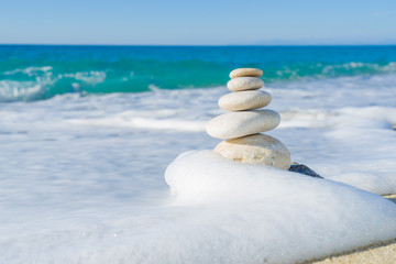 Stones balance, pebbles stack over blue sea in Croatia.