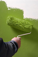 Smooth concrete wall hand painting with paint roller - painter