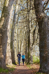 Young running couple jogging in autumn nature