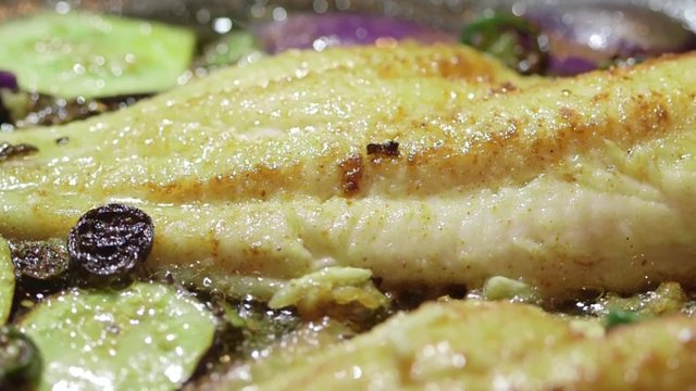 Cooking fish fillet in frying pan