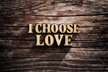 I choose Love. Words on old wooden board.