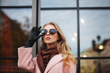 Fashion photo of beautiful young  woman with sunglasses. City lifestyle. Female fashion. Closeup...