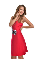 Young beautiful brunette woman posing in modern red dress isolat