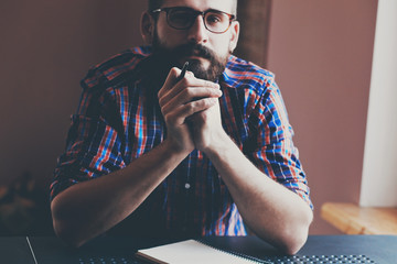 handsome bearded man with pen and notebook