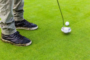 Hitting a golf ball with a putter