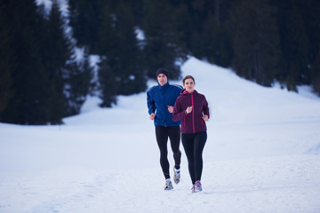 couple jogging outside on snow