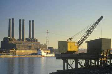 Obraz premium A utility plant and grain barge on the Mississippi River in East St. Louis, Missouri