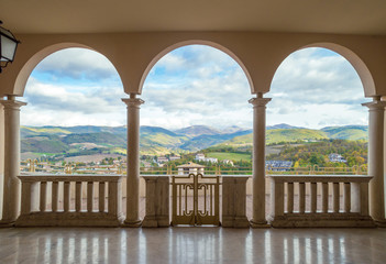 Panorama of hills in Umbria, Italy, seen through three arches 