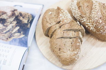 slices of freshly baked multigrain bread on rustic background, square image