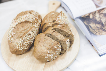 slices of freshly baked multigrain bread on rustic background, square image