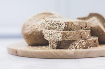 slices of freshly baked multigrain bread on rustic background, square image