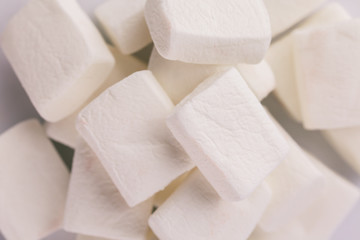 Pile of original marshmallows in red pastel background.