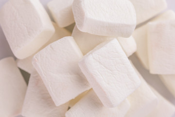Pile of original marshmallows in red pastel background.