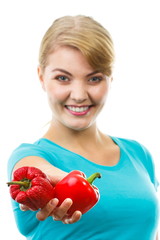 Woman holding in hand fresh and wrinkled peppers, white background