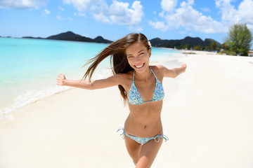 Beach bikini woman happy running with aspiration, joyful, free and playful on Jolly Beach, Antigua...