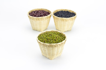 Green bean or mung bean in bamboo basket isolated on white