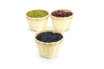 Black beans in bamboo basket isolated on white