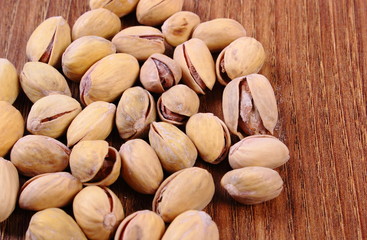 Pistachio nuts on wooden table, healthy eating
