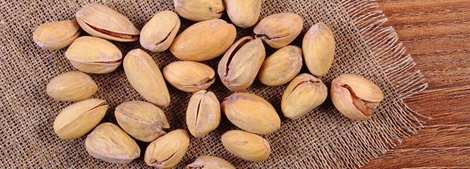 Pistachio nuts on wooden table, healthy eating