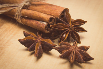 Vintage photo, Cinnamon sticks and anise on wooden table, seasoning for cooking