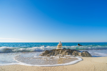 Stones pyramid on sand symbolizing zen, harmony, balance. Ocean