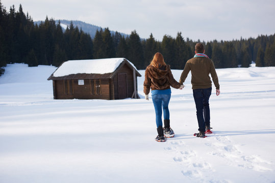 Couple Having Fun And Walking In Snow Shoes